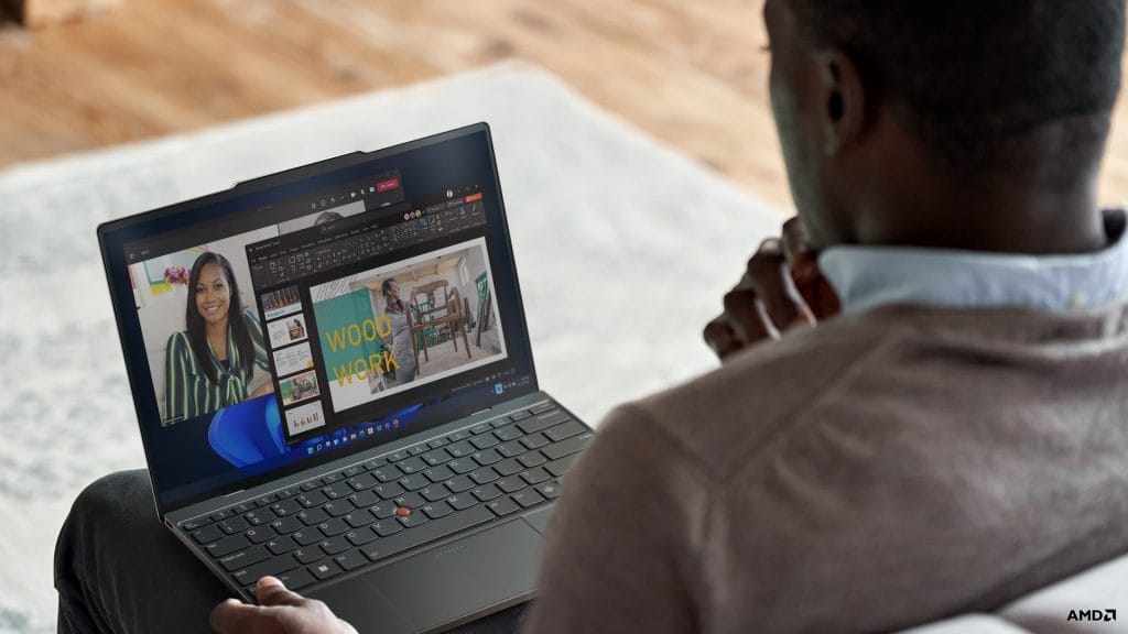 Man engaged in a Teams video call, as seen from behind him Man engaged in a Teams video call, as seen from behind him